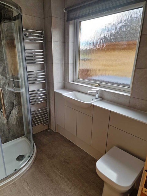 a picture of a renovated bathroom including a shower
