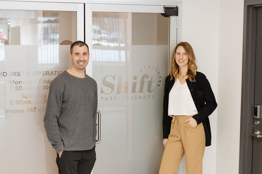 A physiotherapist and pelvic floor physiotherapist stand outside of their physiotherapy clinic in Edmonton.