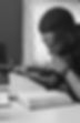 Young Black man reading a book in black and white close-up study