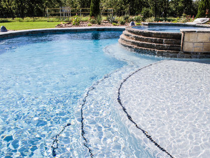 Luxury swimming pool with steps, spa, and beautiful background. Pooltex