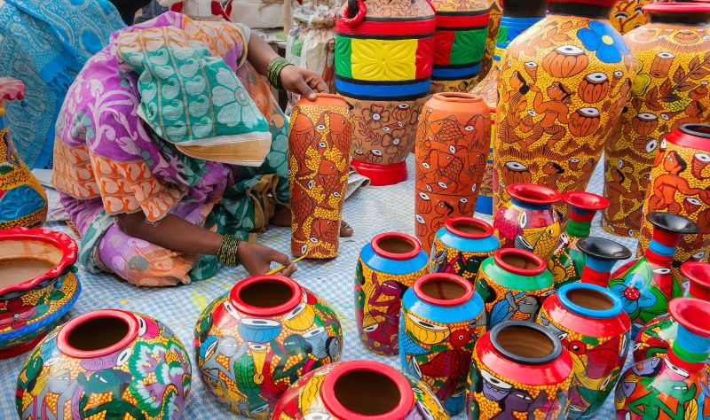 woman artist decorating pottery