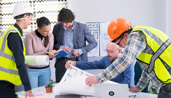 A team of builders, engineers, designers and architects discusses the details of the const