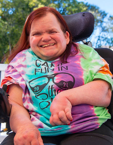 Smiling community member participating in an inclusive community program, photographed with dignity and authenticity
