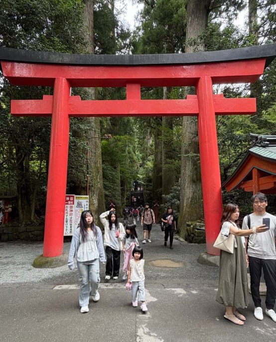 The gate is the entry to the shrine. The 400 year old trees seem To be the guardians of the trail.