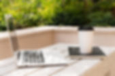 side-view-laptop-with-coffee-cup-outdoors.jpg