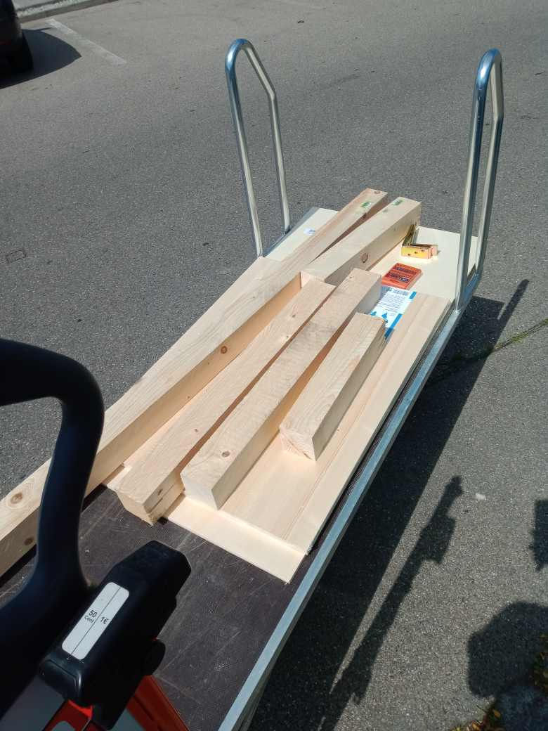 Ein Bauhaus-Wagen mit Holzbalken darauf.