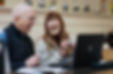 Elderly man and lady at laptop