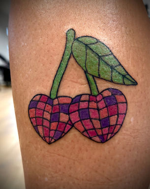 Disco cherry purple tattoo done by our professional tattoo artist in our sheffield based tattoo studio for best price in the city