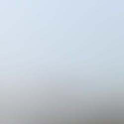 Person rows into a foggy sea in a tiny rowboat. Image by Geda Zyvatkauskaite on Unsplash.