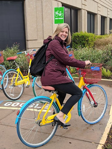 blond-woman-on-multicolor-bike-on-google-campus
