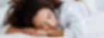 Woman in white shirt naps on bed covered in white blankets. Image by Thirdman on Pexels.