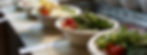 Custom green salads are lined-up next to each other for pick-up by customers. Image by Brian J. Tromp on Unsplash.