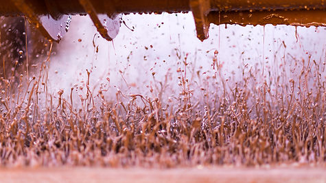 closeup on drilling fluids bouncing off the shale shaker.jpg