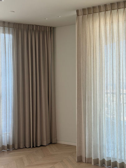 Beige sheer curtains in a room near a window Anna Amiel Textile