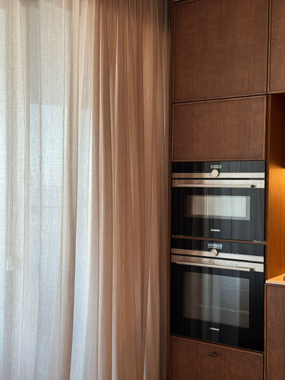 Modern kitchen interior with oven and a sheer white curtain Anna Amiel Textile