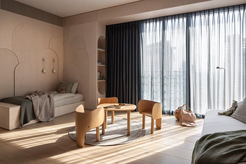 Cozy children's room with bed, table, chairs, and large window Anna Amiel Textile