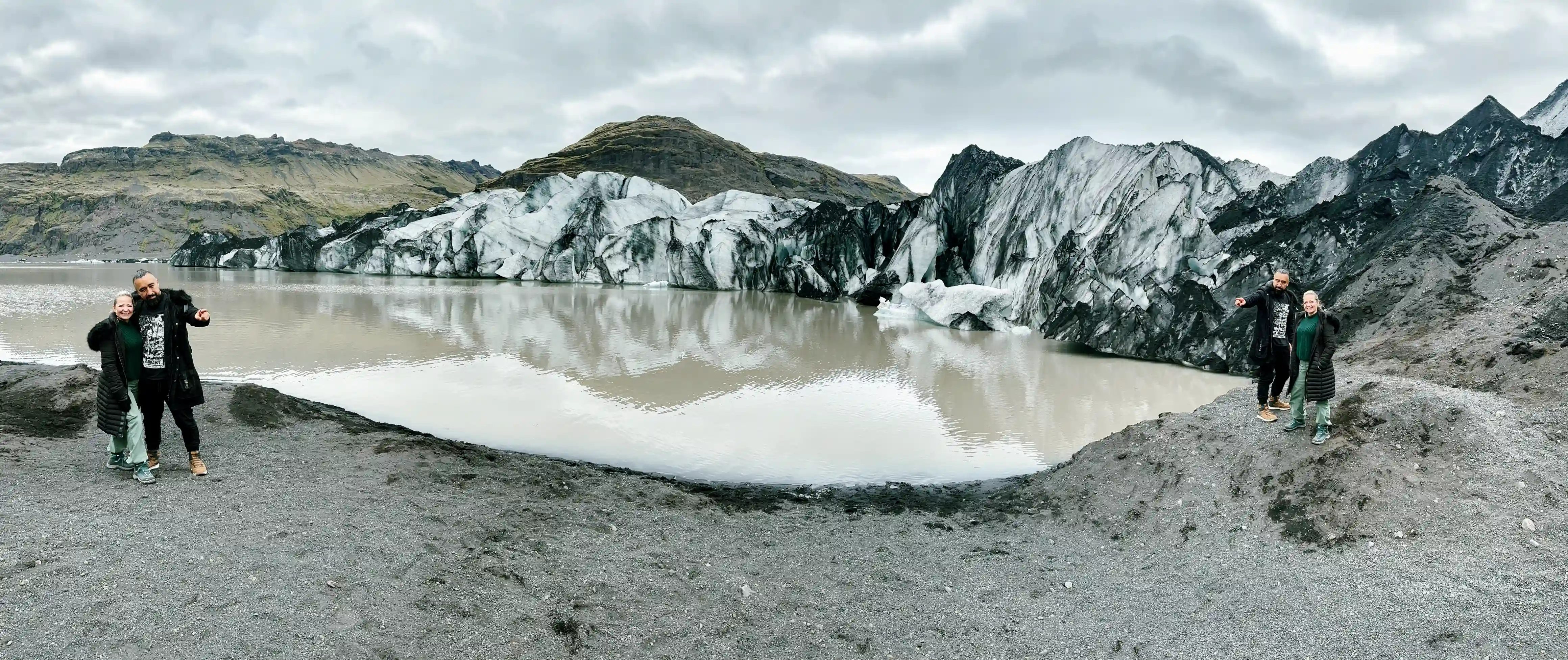 A couple at Solheimajokull Glacier tongue in Iceland, doing the Private South Coast Tour w