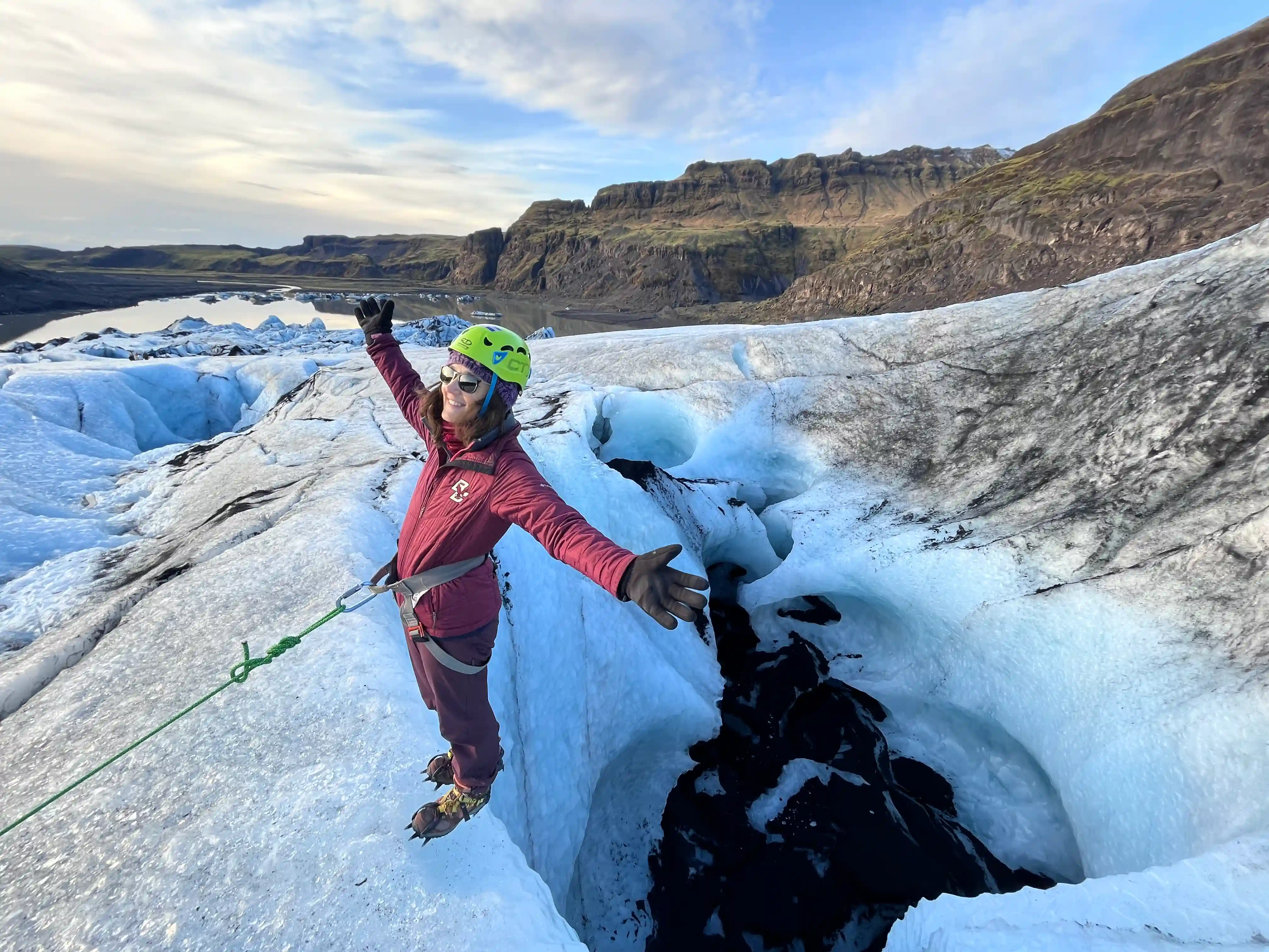 Woman stading over the glacier in Iceland while glacier hiking around the Blue Ice i Solhe