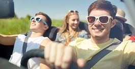 Teens driving a convertible