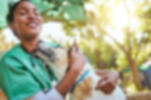 A vet shares a joyful moment with a dog, highlighting efforts to prevent veterinary suicide and promote mental well-being.