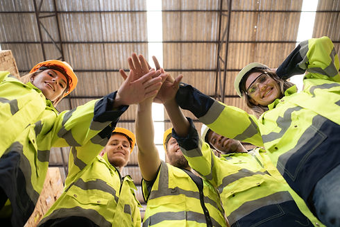 vecteezy_portrait-of-happy-workers-giving-high-five-at-warehouse_31608034.jpg
