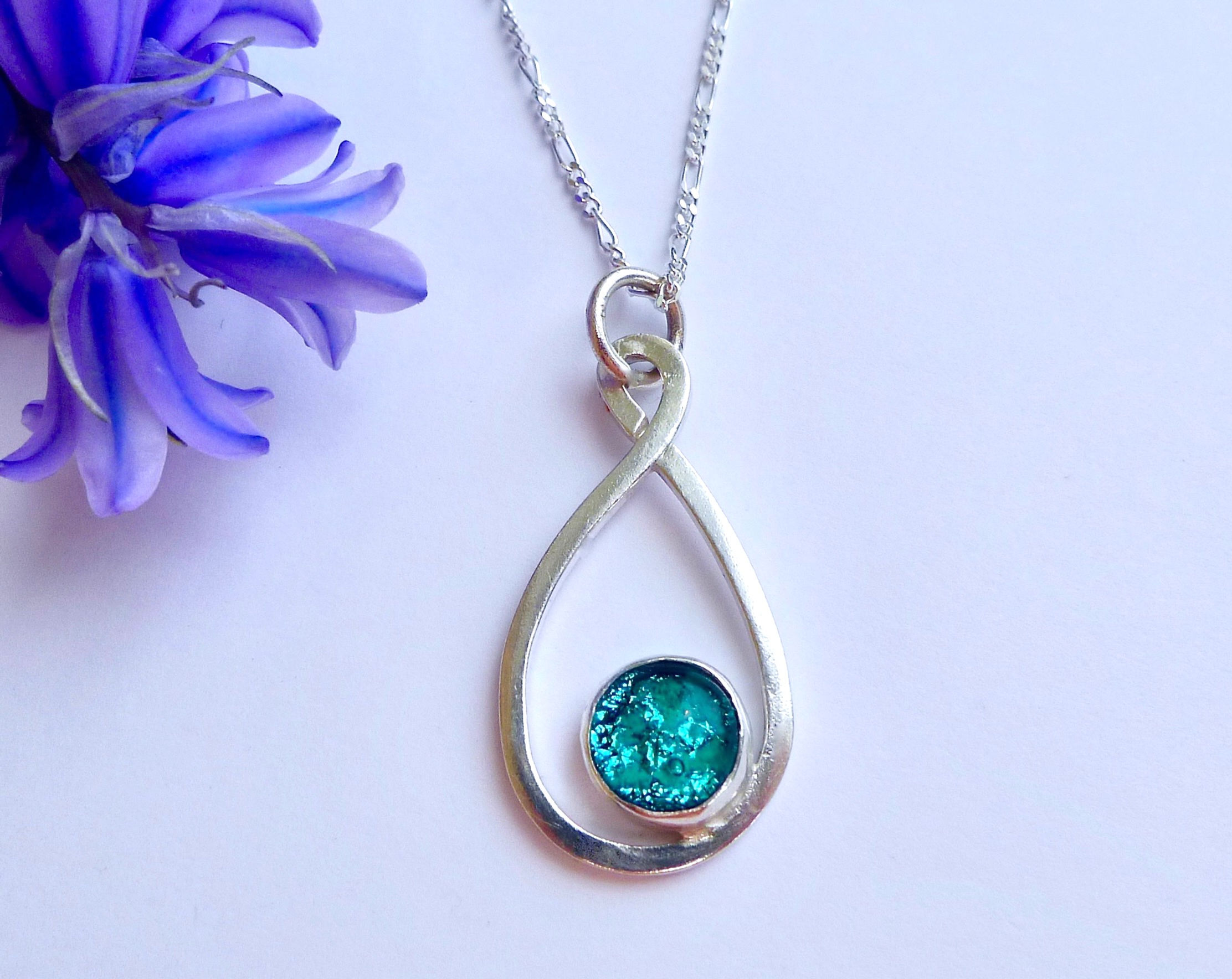ashes jewellery, ashes in glass infinity necklace, aquamarine ashes in glass necklace