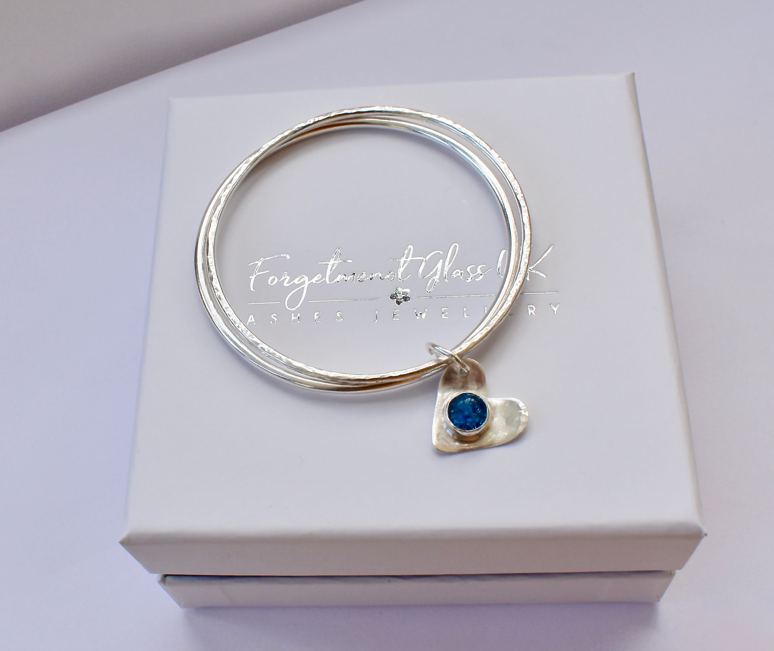 ashes jewellery, ashes in glass jewellery, ashes heart charm set onto silver bangle