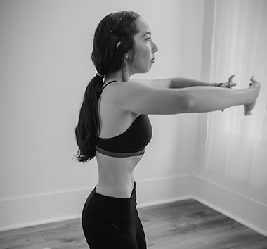 A woman performing a hypopressive exercise or abdominal vacuum or apnea