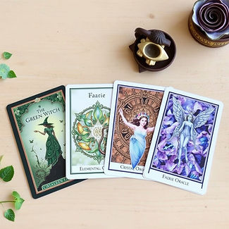 4 oracle card decks - the green witch, the elemental oracle, Crystal Oracle cards and faer
