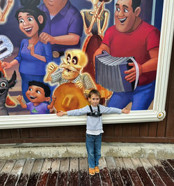 Gabe in Front of Coco Sign at Disneyland Adventure Park