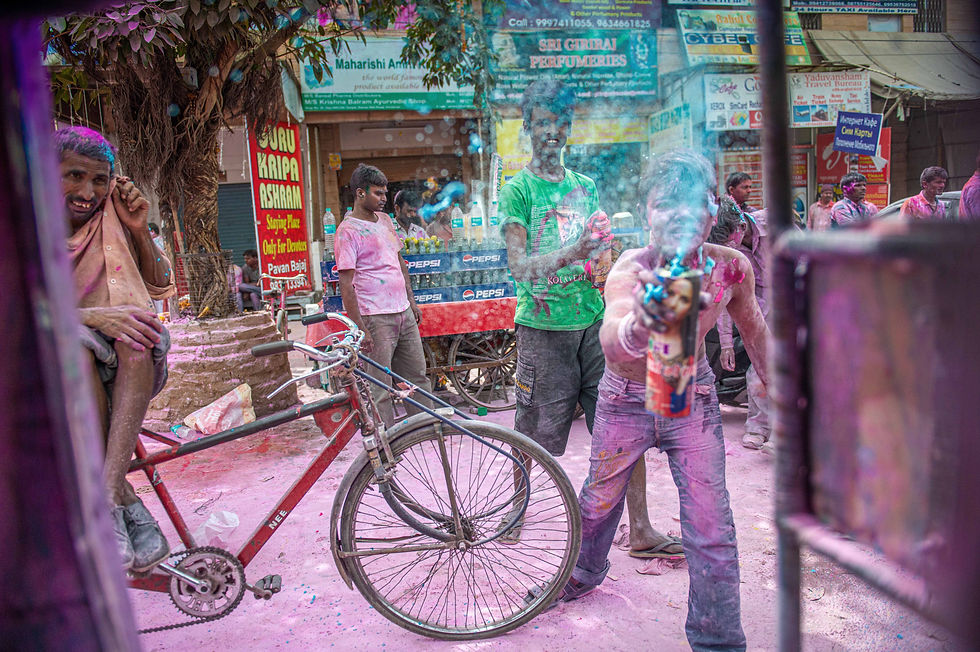 You cannot escape being covered in coloured powder or liquid during the Holi festival in the holy to