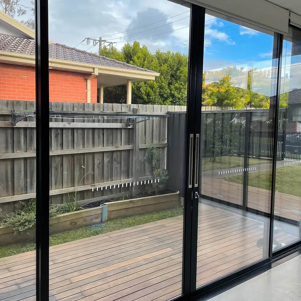 Streak-free floor-to-ceiling glass sliding doors and deep cleaned black aluminum window tracks detailed by Whole Detail.
