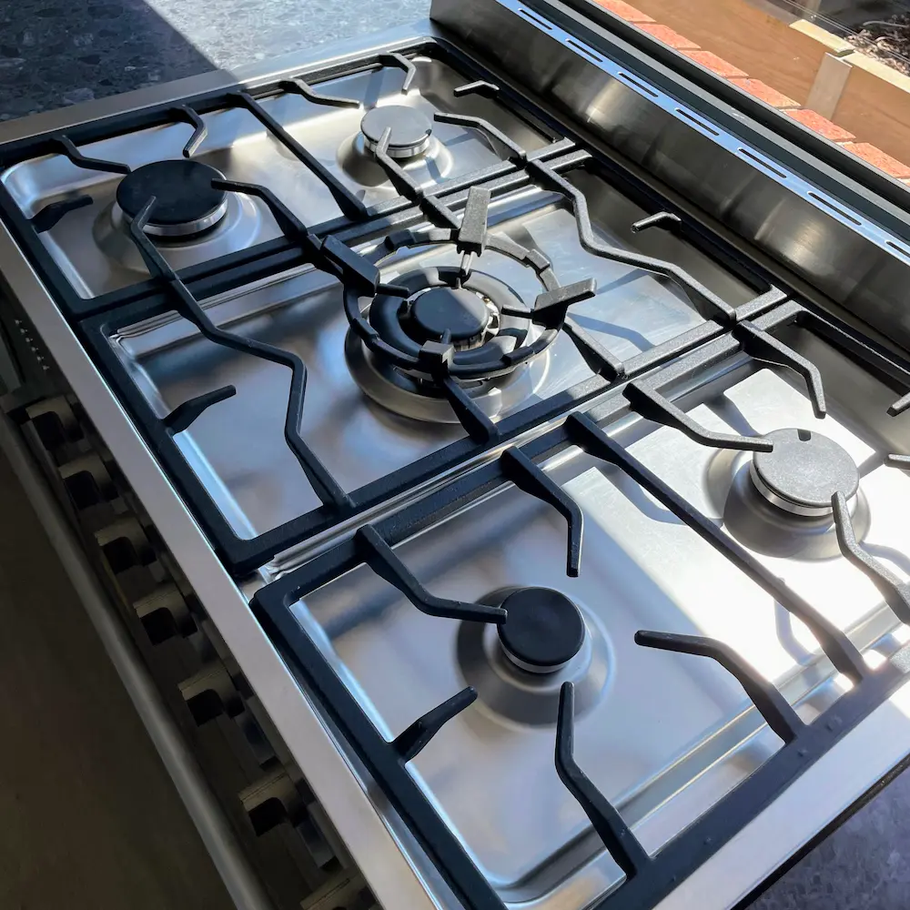 Five-burner commercial-style gas cooktop and stainless steel hob degreased and detailed by Whole Detail