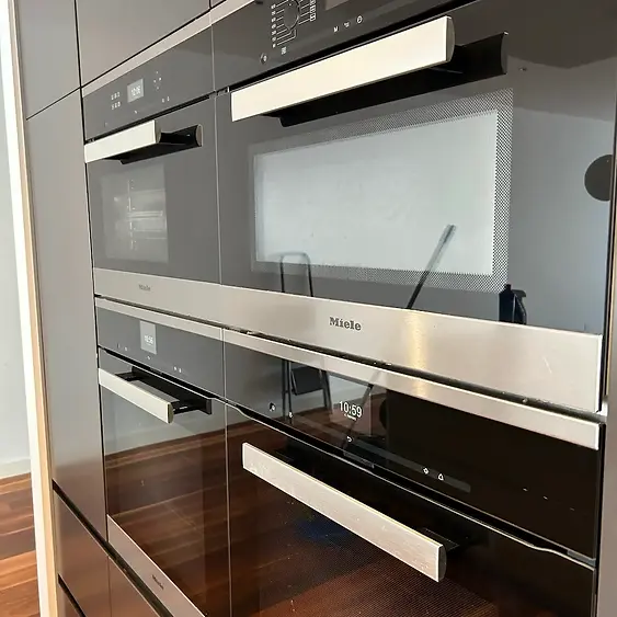 Integrated Miele double oven glass and brushed stainless steel fascia degreasing during a premium Sandringham spring cleaning service by Whole Detail.
