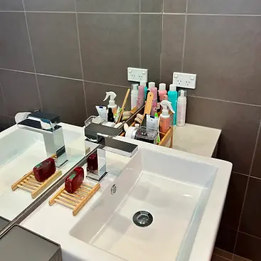 Polished square chrome tapware and organized vanity mirror reflection detailing during a regular recurring Cheltenham home cleaning service by Whole Detail.