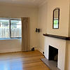 Dust-free living room featuring clean timber floors, architraves, and detailed fireplace mantel.