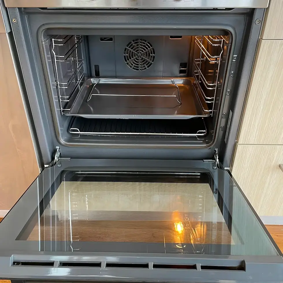 Fully restored open oven interior, spotless glass door void, and decarbonised wire racks detailed by Whole Detail.