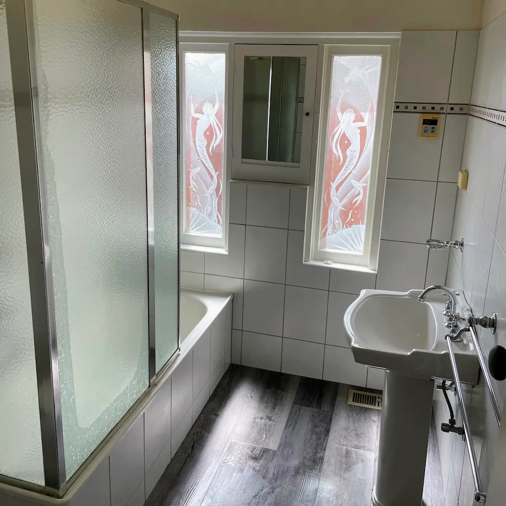 Central family bathroom suite featuring descaled shower enclosure, pedestal basin, and wall tile restoration by Whole Detail. 