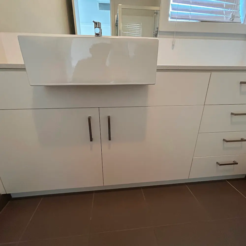 Master bathroom vanity, ceramic basin, and mirror surface descaled and polished by Whole Detail. 