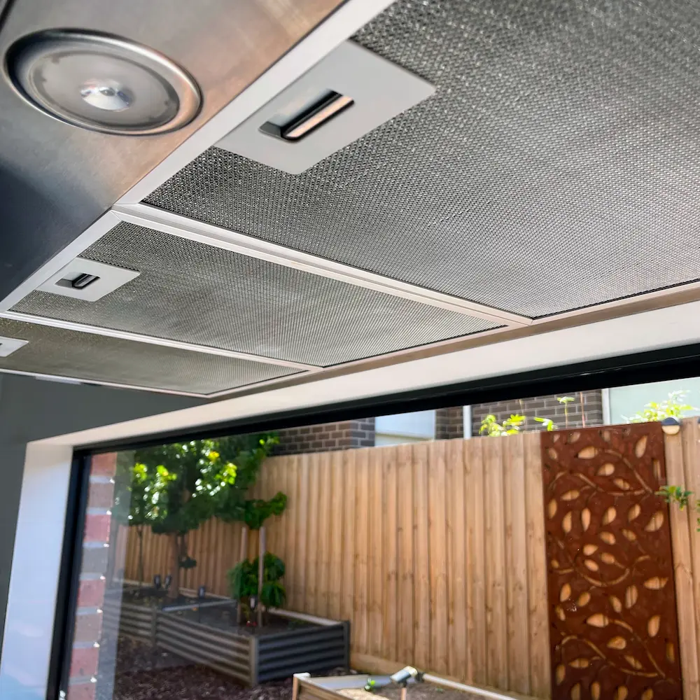 Underside of stainless steel rangehood canopy and clean aluminum mesh filters restored by Whole Detail. 