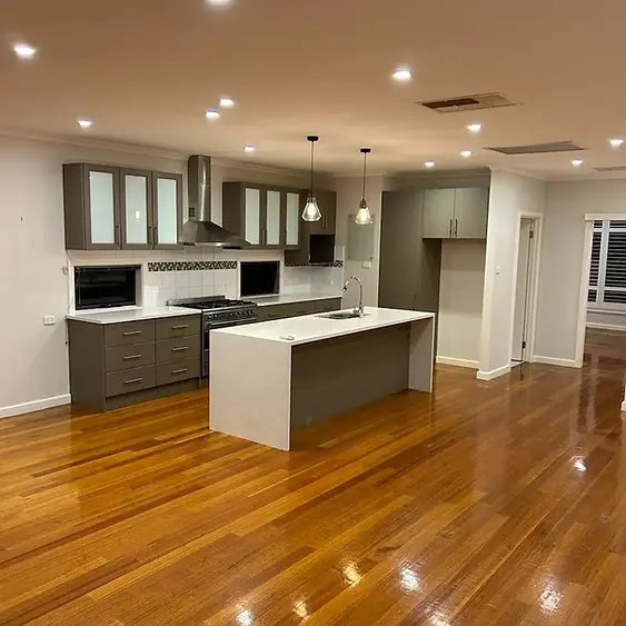 High-gloss timber floor polish reflection and modern engineered stone kitchen island detailing inside a premium Cheltenham family residence by Whole Detail.