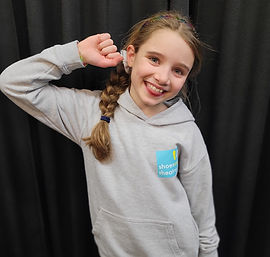 Drama student smiling, wearing a Shoes on Theatre hoodie.jpeg