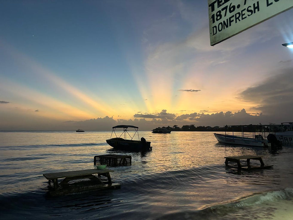 Caribbean sunset over the water with boats near Negril, Jamaica