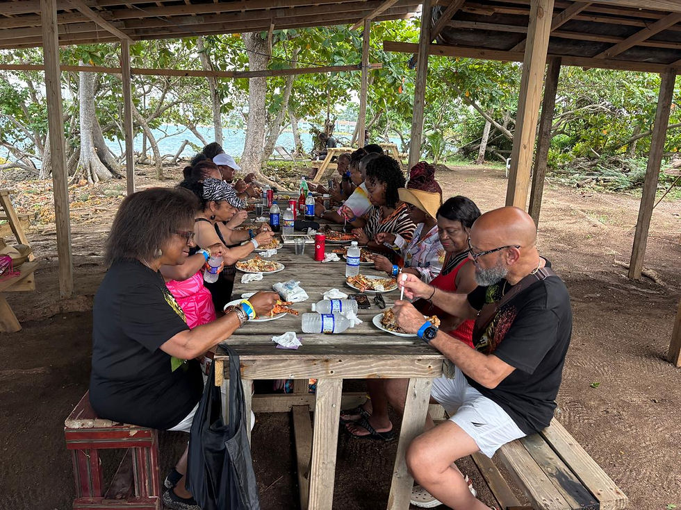 Guests enjoying a freshly prepared meal together beneath an open-air shelter on Booby Cay, Jamaica