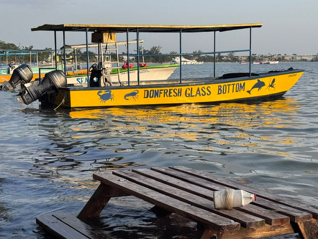 DonFresh Lobsters yellow glass-bottom tour boat on the water in Negril, Jamaica