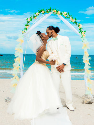 Newlywed portrait on Dania Beach, FL  pre-erosion circa 2016. The groom made this arch for his wife.