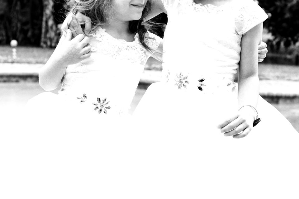 black and white photo of some cute flower girls before the wedding