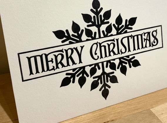 A letterpress printed Christmas card with black ink on 100% cotton paper.