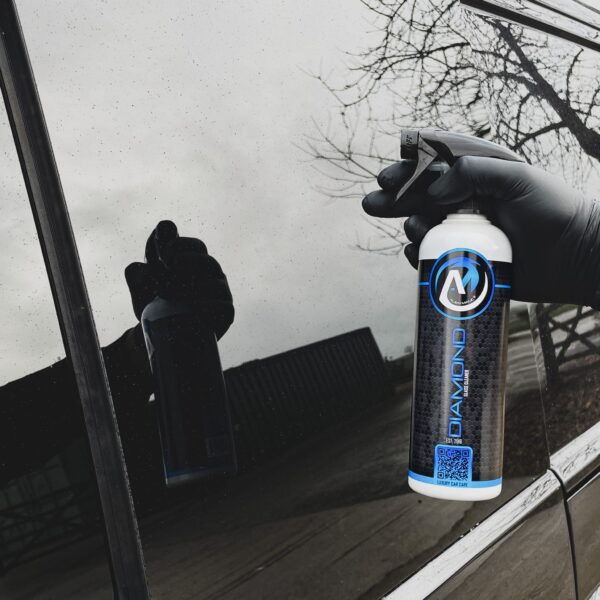 bottle of Alien Magic | Diamond | Glass Cleaner | 500ml against a car window