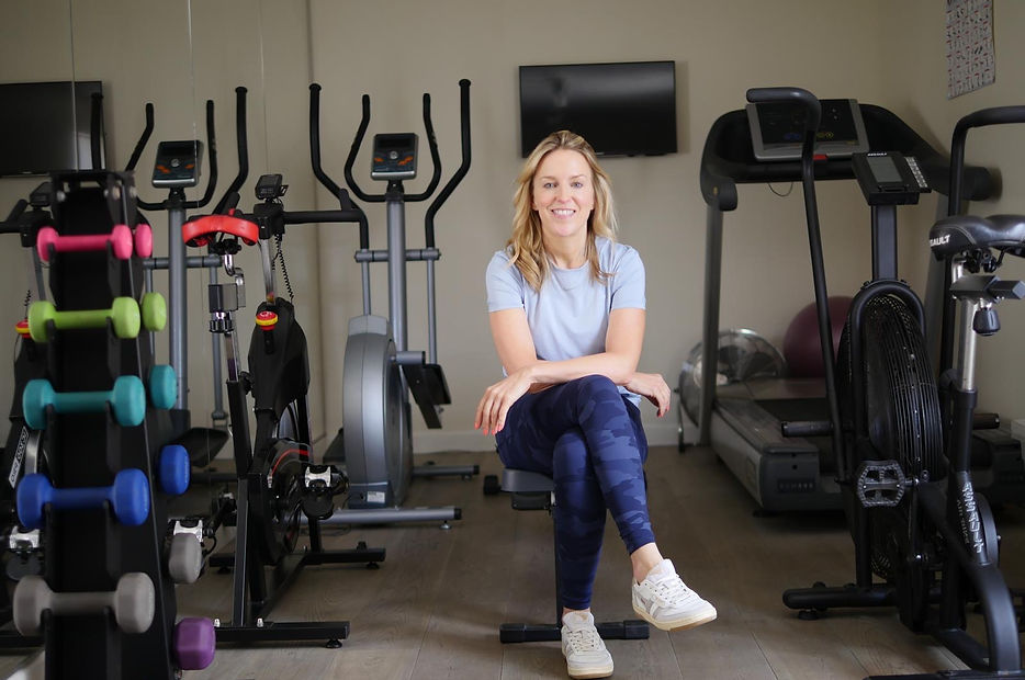 Eleanor, personal trainer, smiling and ready to guide clients through a workout